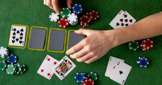 Hände bewegen Pokerchips und Karten auf grünem Filz, während die Spielsituation Drawing Dead beim Poker dargestellt wird.